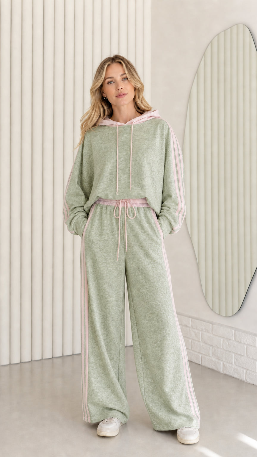 Woman wearing Sage Green two-piece tracksuit set with pink striped details