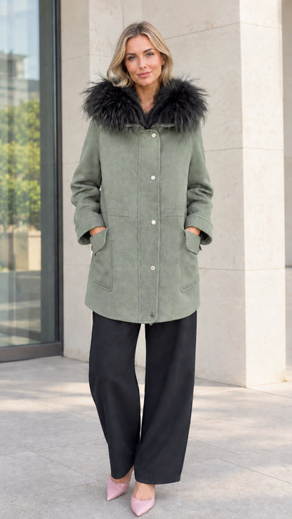 Front view of model wearing sage green faux fur hooded mid-length parka coat