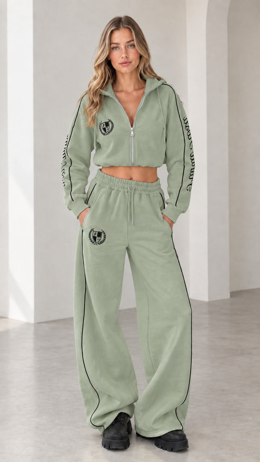Front view of model wearing sage green cropped hoodie and wide-leg sweatpants tracksuit set