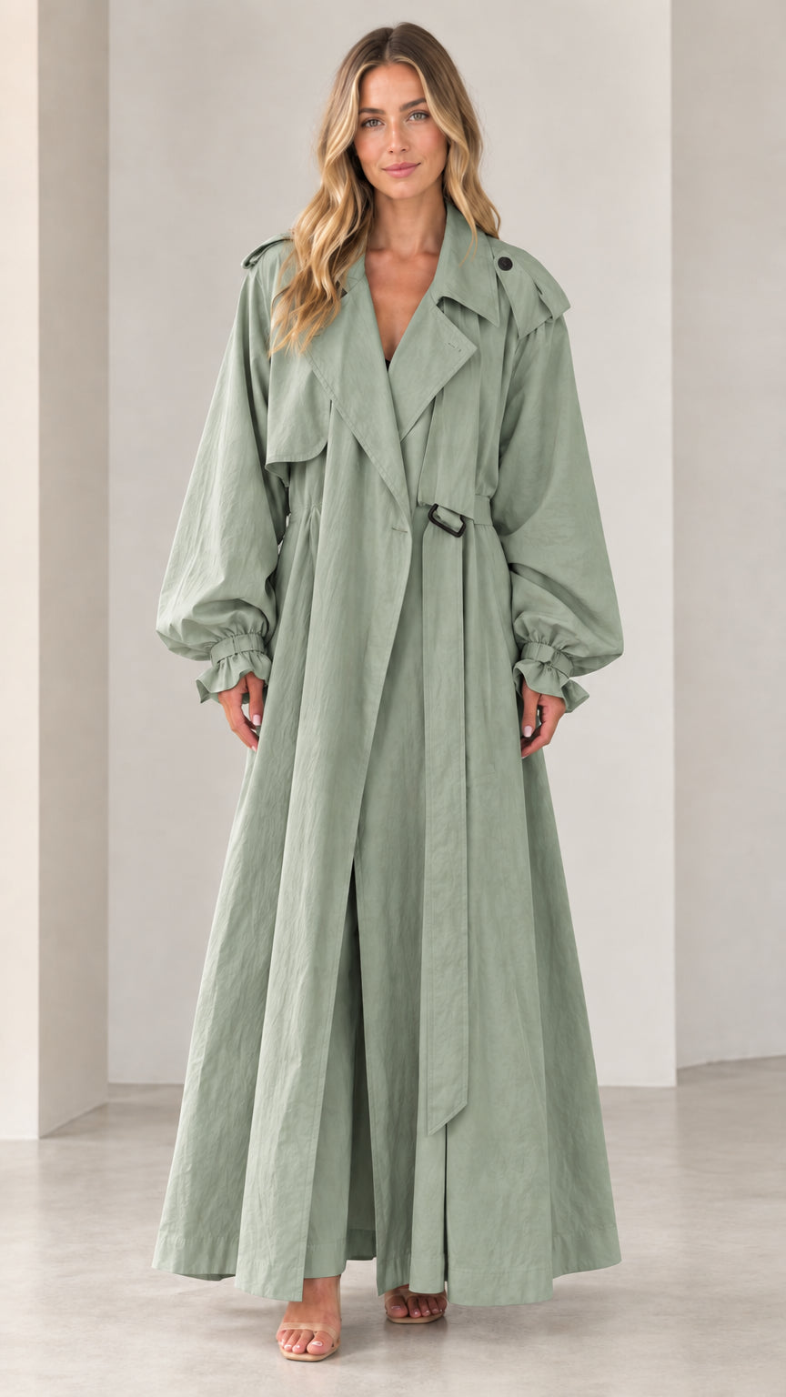 Front view of woman wearing full-length sage green belted maxi trench coat