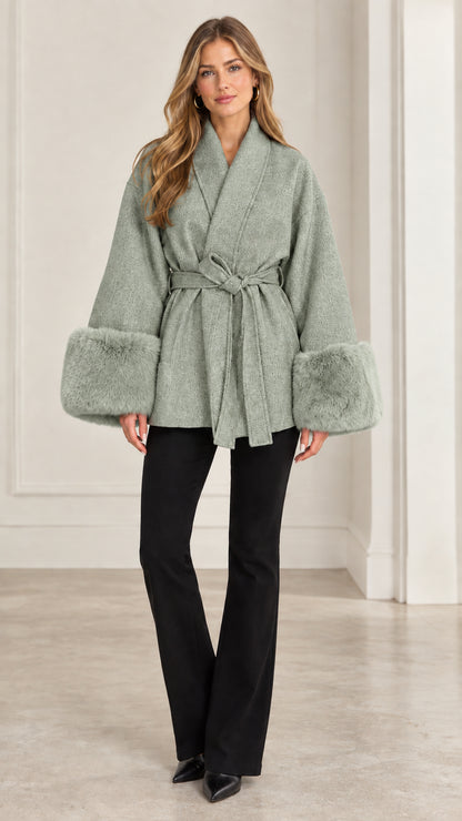 Front view of model wearing sage green faux fur cuff belted short coat