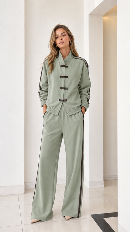 Full front view of women's sage green two-piece tracksuit with contrast stripes