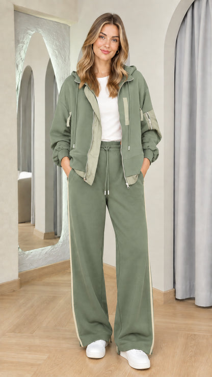 Woman wearing sage green matching zip-up hoodie and track pants set