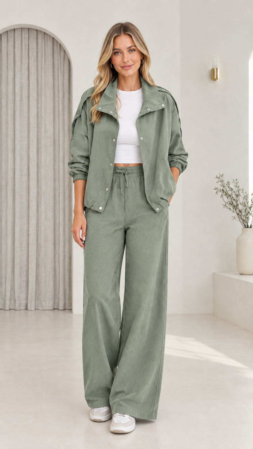 Front view of model wearing sage green utility jacket and wide-leg pants set