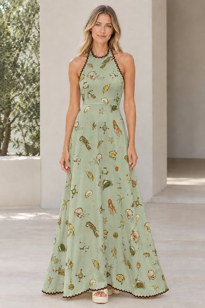 Model wearing sage green nautical print halter maxi dress