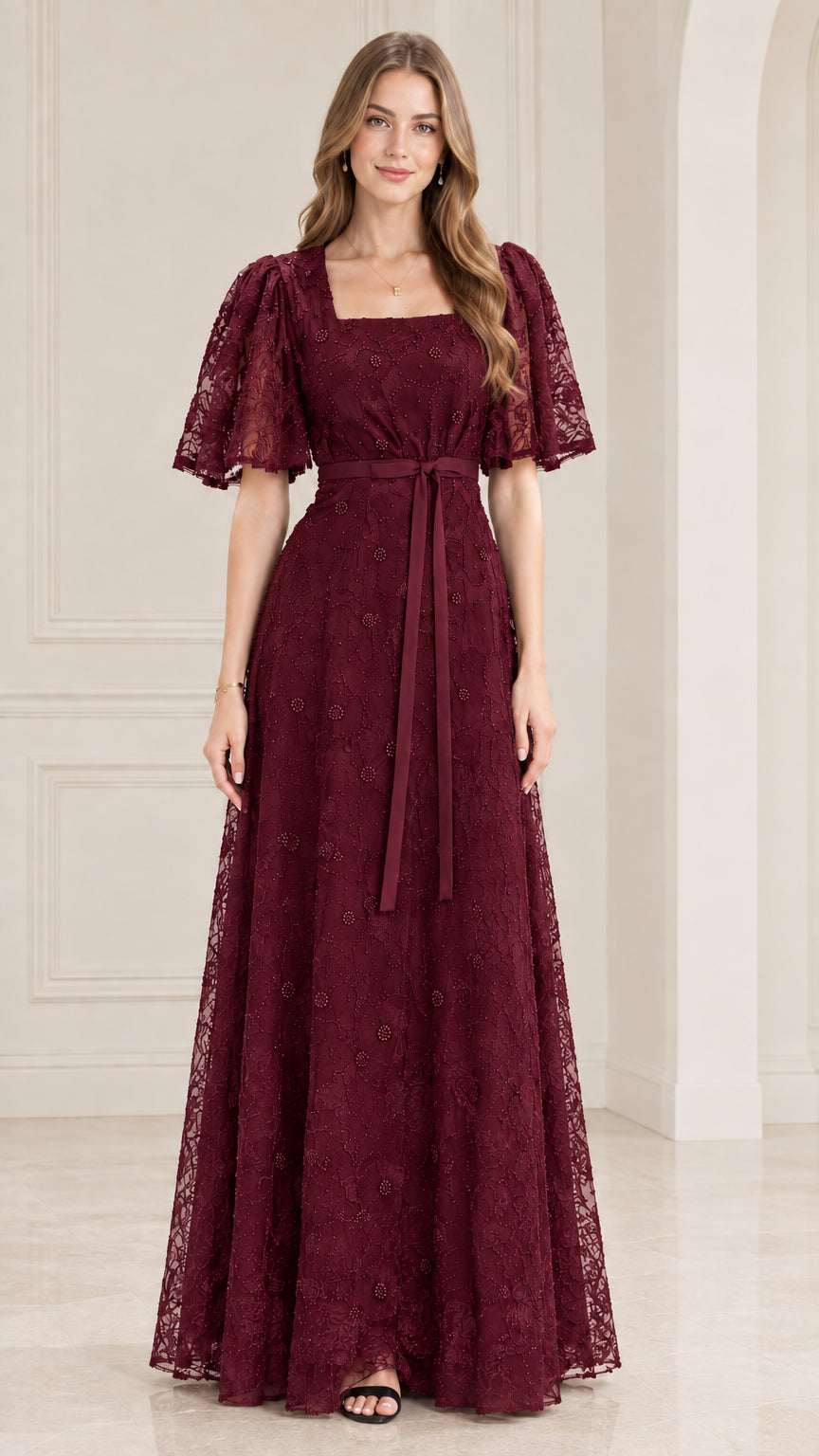 Front view of model wearing burgundy wine lace flutter sleeve maxi gown