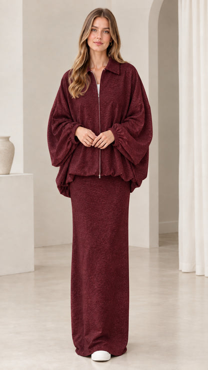 Model wearing burgundy wine red zip-front jacket and maxi skirt set