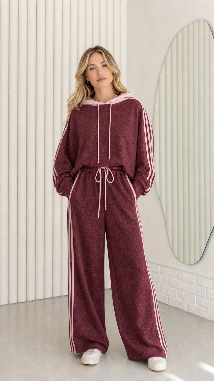 Woman wearing Burgundy two-piece tracksuit set with contrast pink side stripes