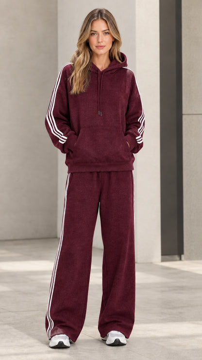 Model wearing burgundy red 2-piece striped hoodie and wide-leg sweatpants set