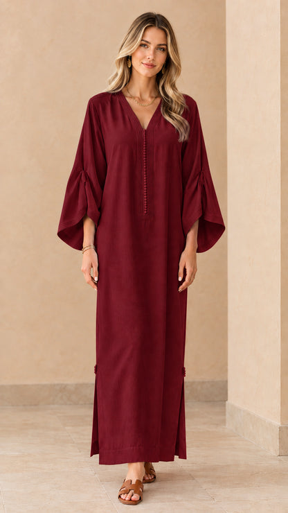 Front view of woman wearing burgundy wine red long kaftan dress