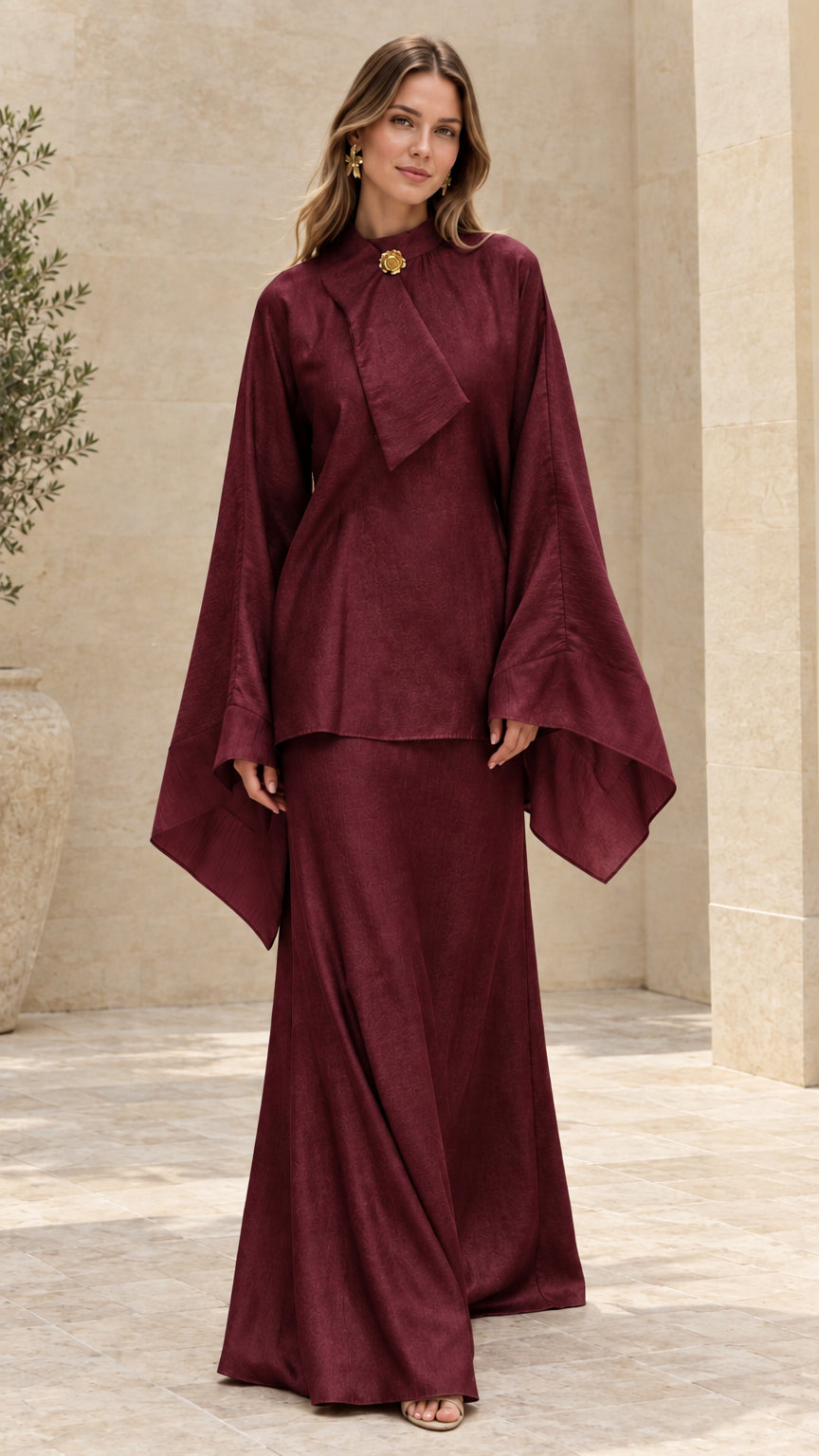 Model wearing rich burgundy flared sleeve tunic and maxi skirt two-piece set
