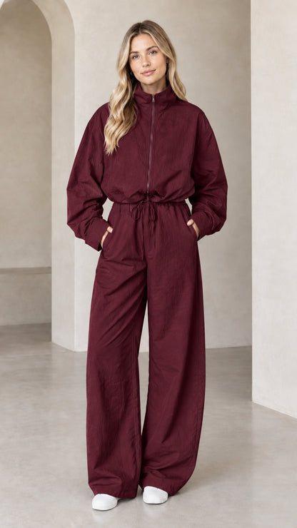 Front full-length view of woman wearing Burgundy zip-up wide-leg utility jumpsuit