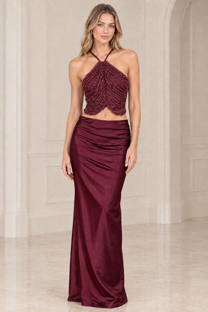 Burgundy wine two-piece formal set featuring beaded halter bodice and satin maxi skirt