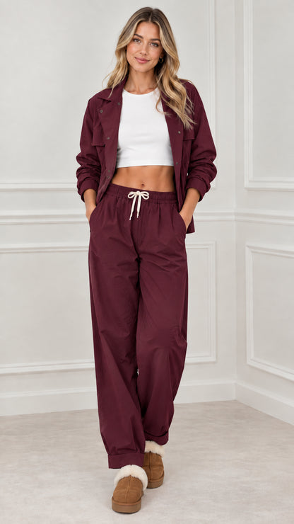 Full front view of woman wearing burgundy two-piece utility jogger pant set