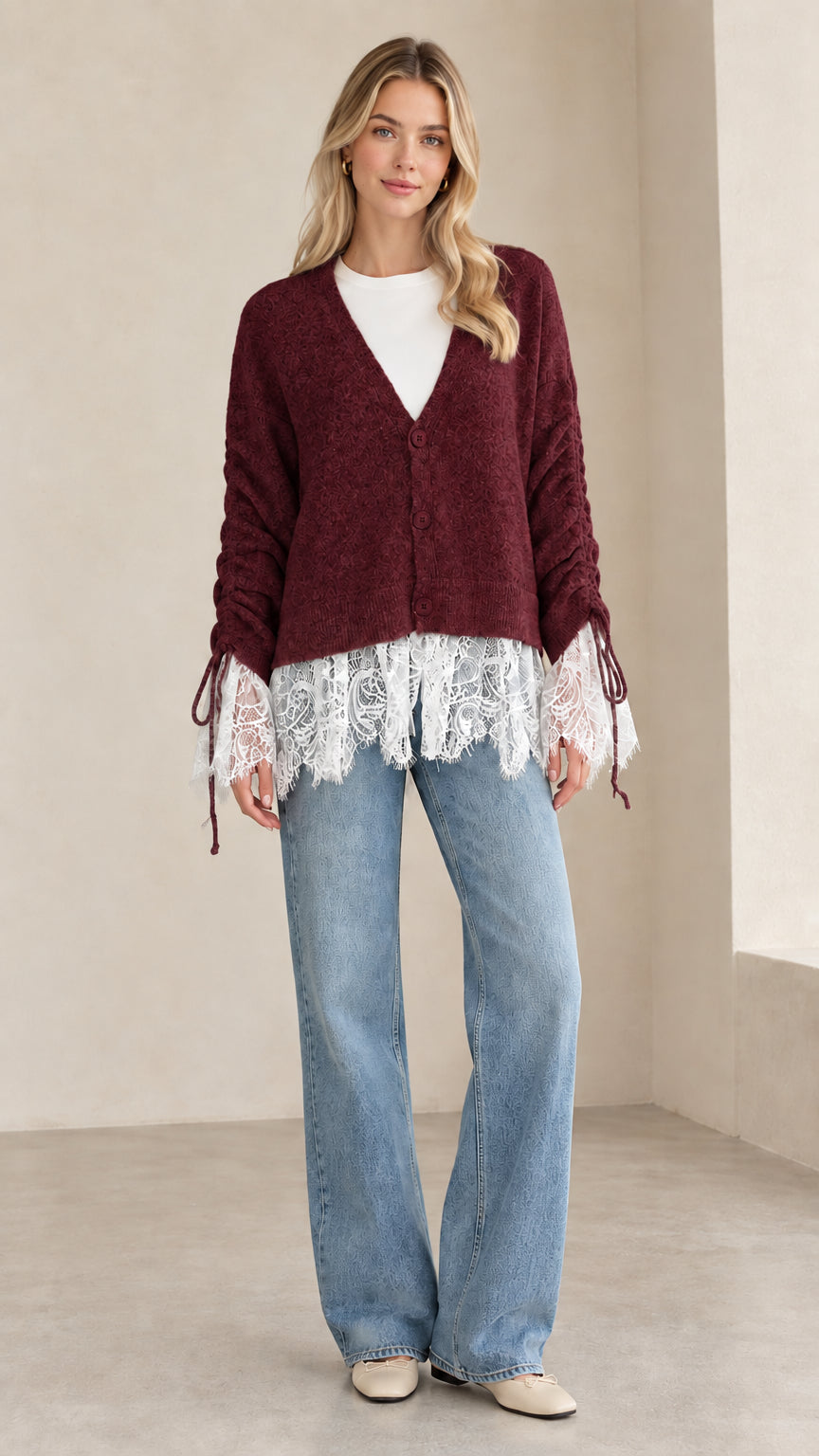 Front view of woman wearing burgundy V-neck lace-trimmed knit cardigan