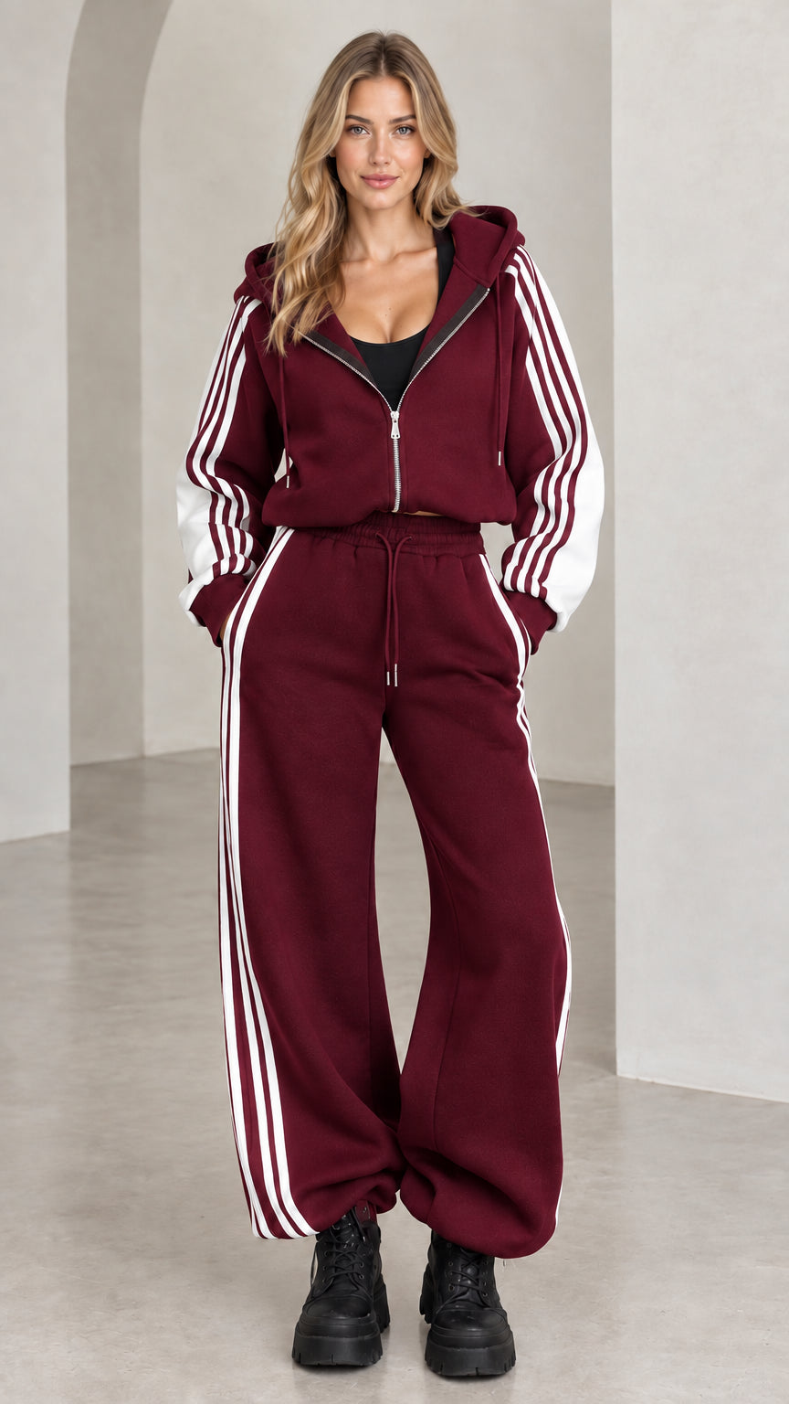 Front view of model wearing burgundy wine red two-piece striped tracksuit set