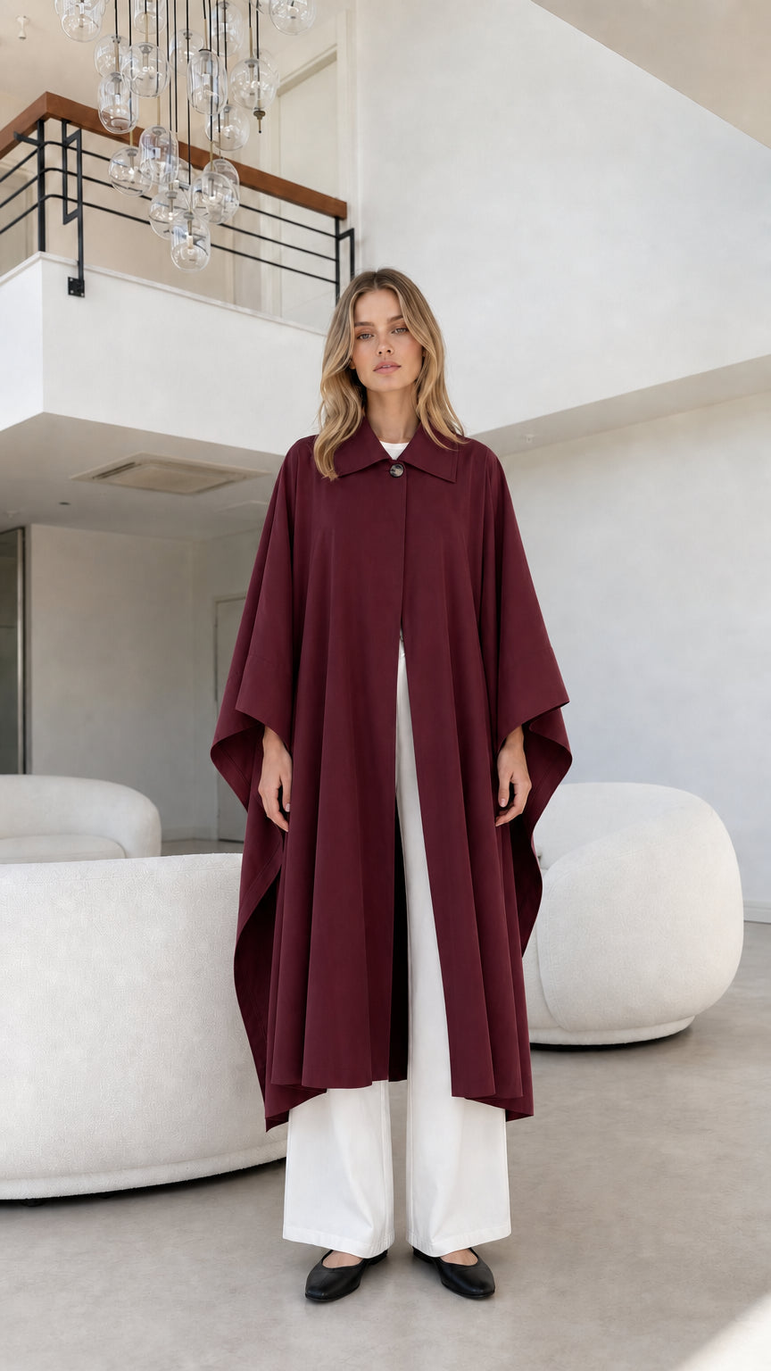 Full front view of model wearing deep burgundy wine longline cape coat