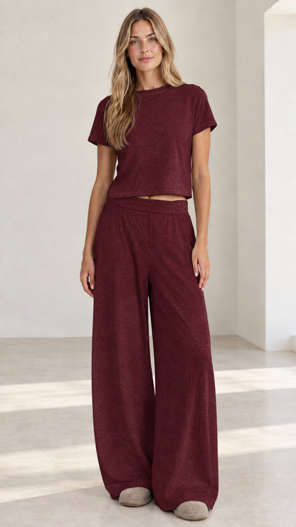 Model wearing burgundy wine red short sleeve crop top and wide leg pants set