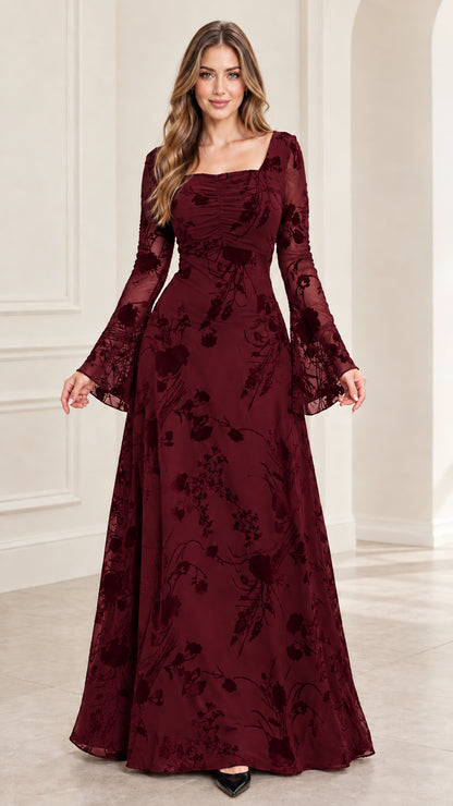 Front view of model wearing burgundy red floral burnout evening gown