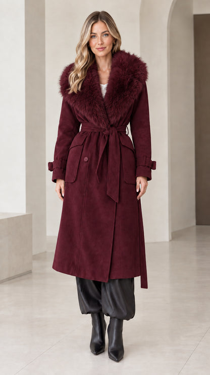 Front view of model wearing deep burgundy belted long coat with faux fur trim