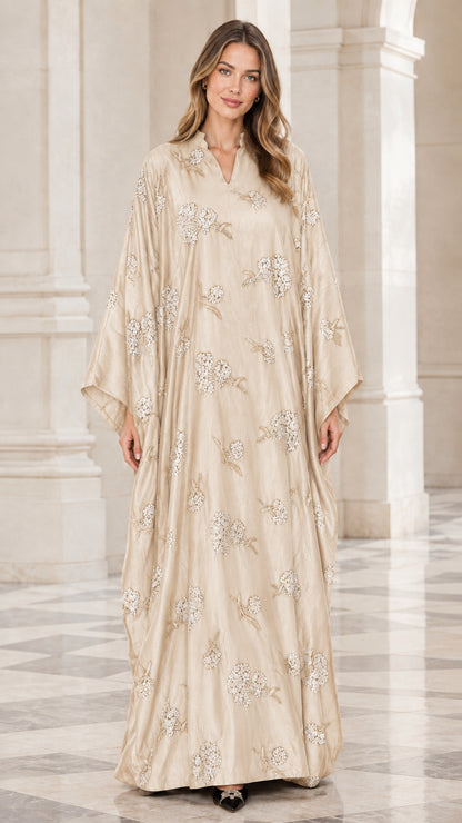 Front view of woman wearing champagne beige floral embroidered kaftan maxi dress