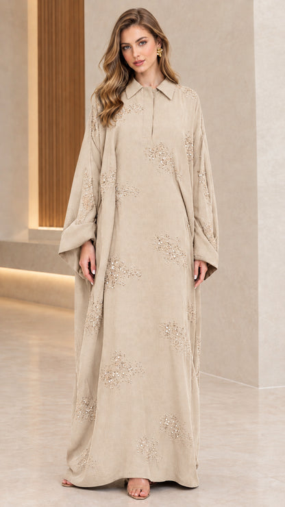 Front full-length view of woman wearing beige champagne collared sequin embellished abaya maxi dress