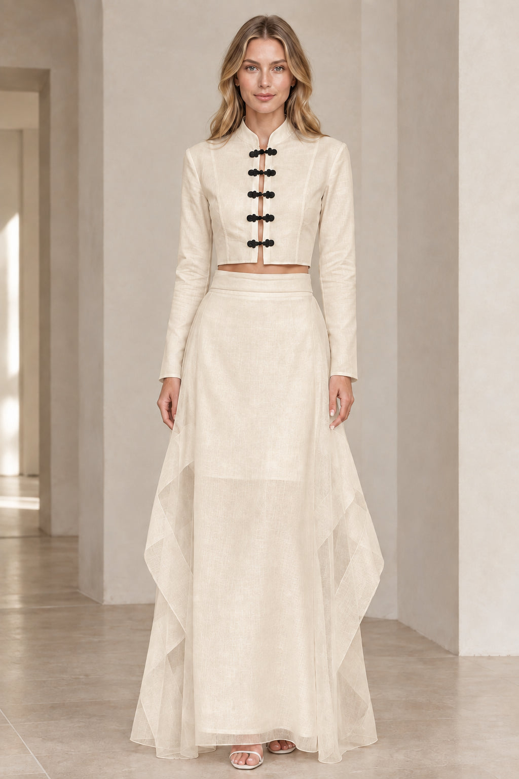 Front view of model wearing beige cream mandarin collar crop top and maxi skirt set