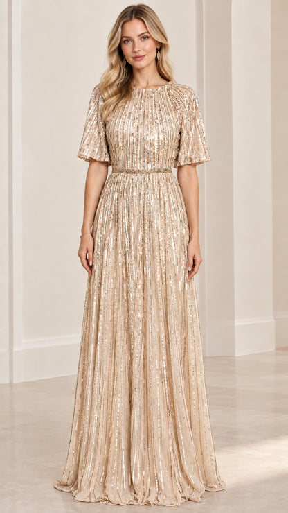 Front view of woman wearing champagne gold sequin pleated maxi gown