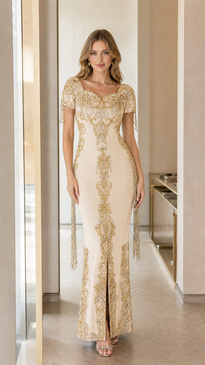 Front view of champagne cream floor-length formal gown with ornate gold embellishments