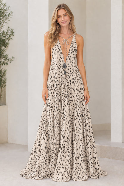 Model wearing beige tan dotted sleeveless plunge tiered maxi dress