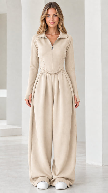 Full-length front view of model wearing beige cream quarter-zip top and wide-leg pants set