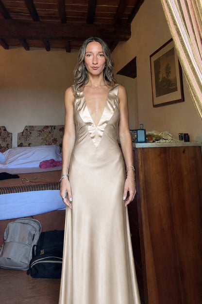 Front view of champagne gold deep V-neck satin maxi dress