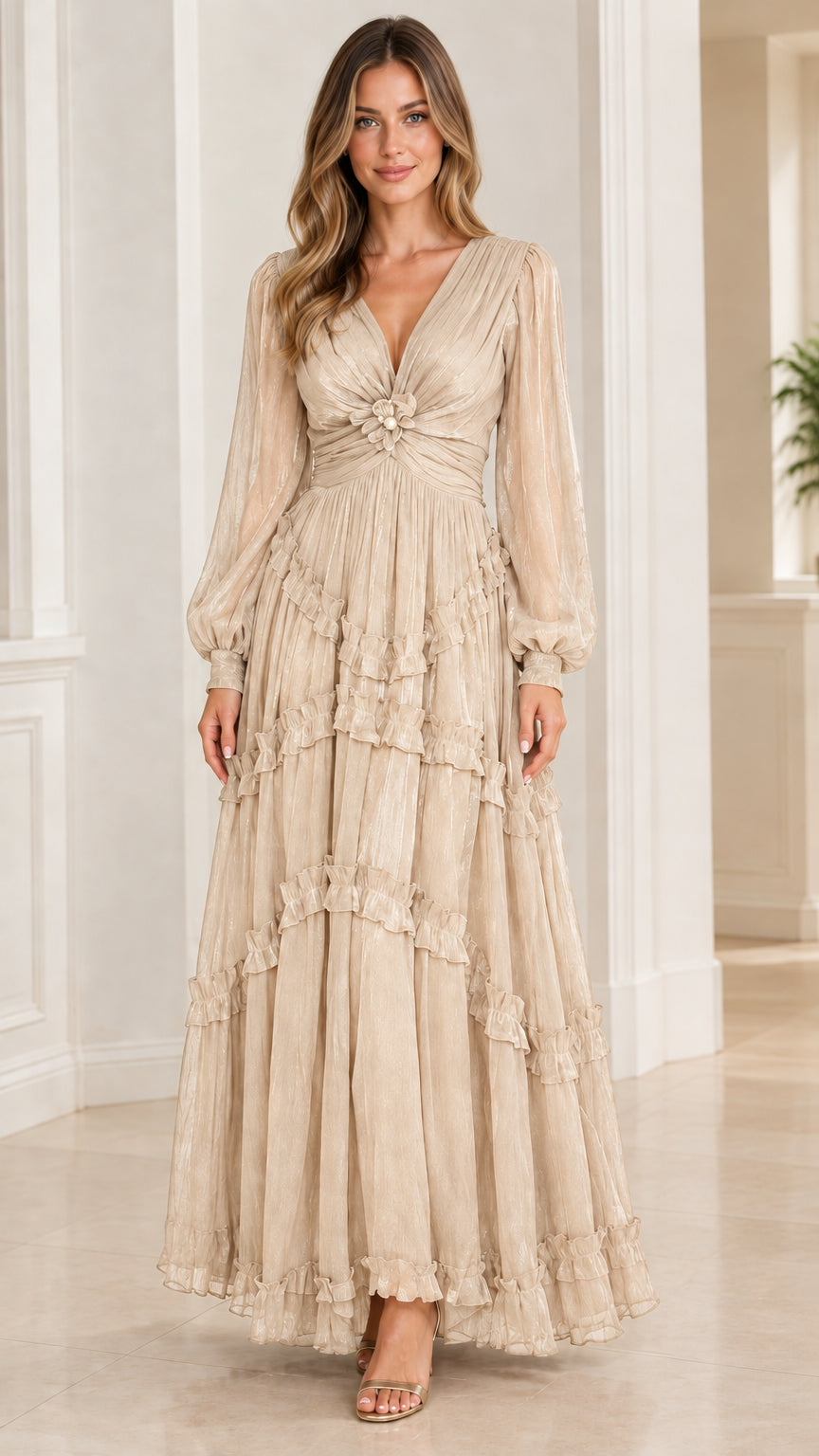 Model wearing champagne beige long sleeve tiered plissé maxi evening dress