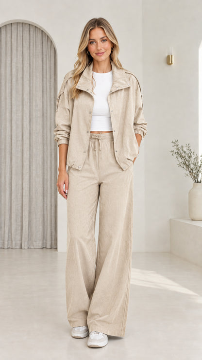 Front view of model wearing beige neutral utility jacket and wide-leg set