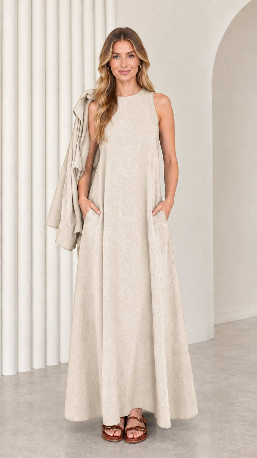 Front full-length view of model wearing the beige oatmeal sleeveless maxi dress with matching drape