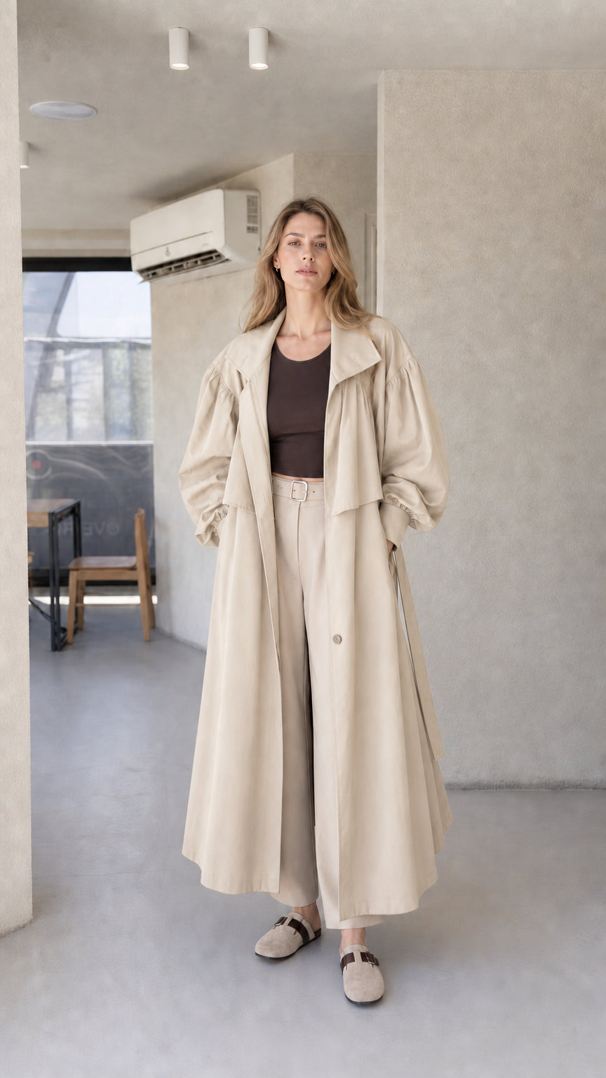 Model wearing light beige cream oversized maxi trench coat with lantern sleeves